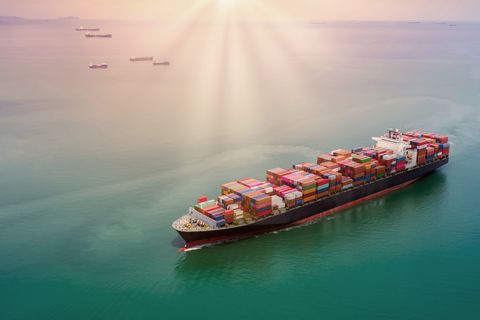 Container cargo ship at sunset