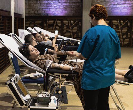Blood Donors laying on beds giving blood