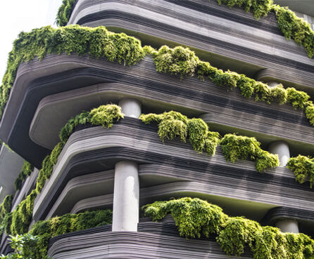 Close up of a business building with plant decorated balconies