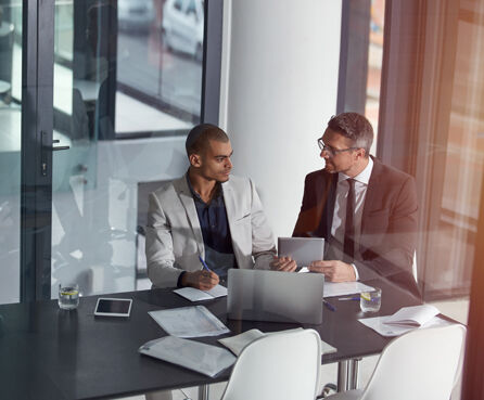 Businessmen having a meeting, holding tablet and planning collaboration for finance strategy