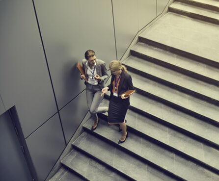 Businesswoman talking while walking down the stairs