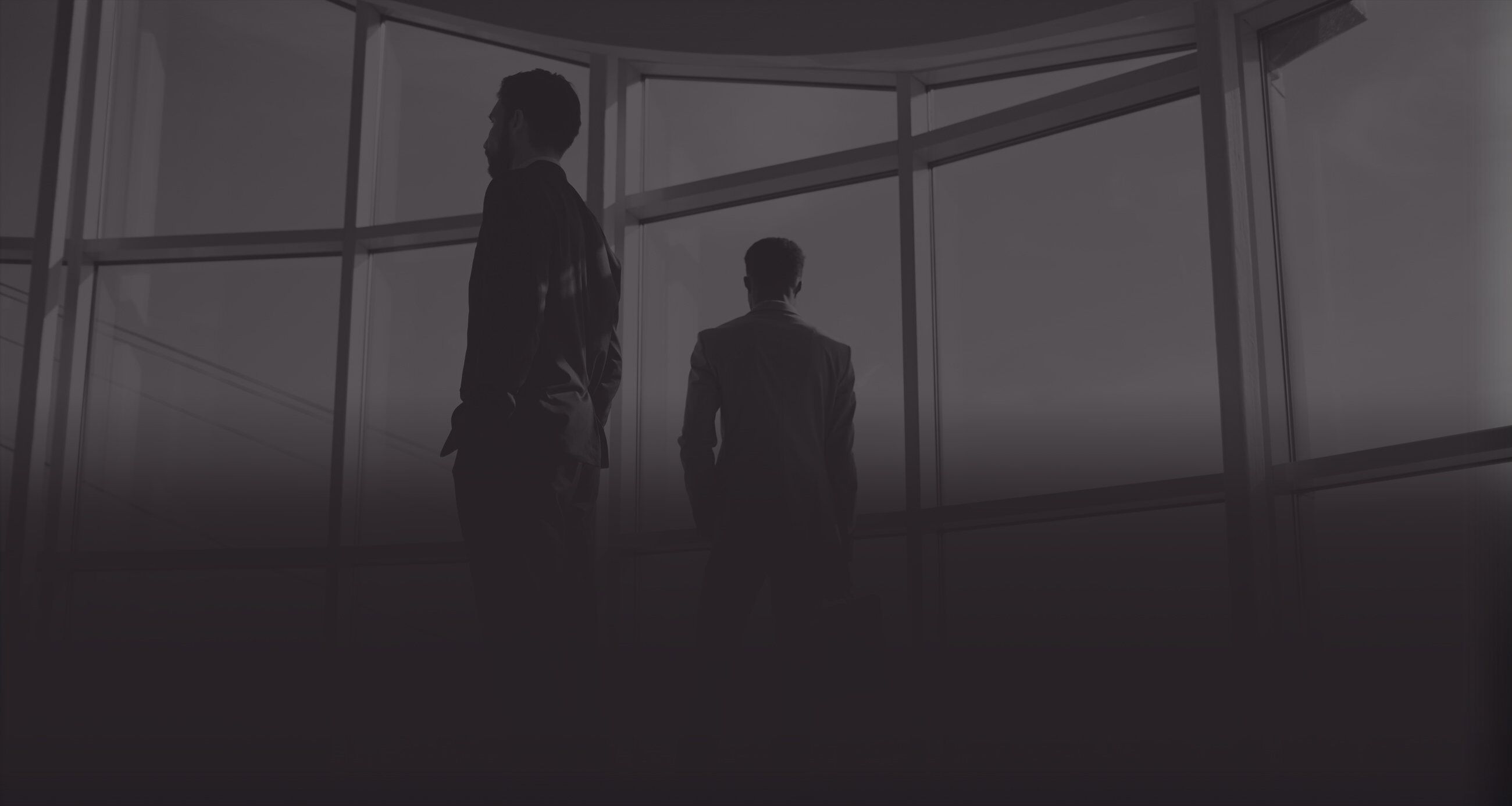 Men standing in office looking out of the window