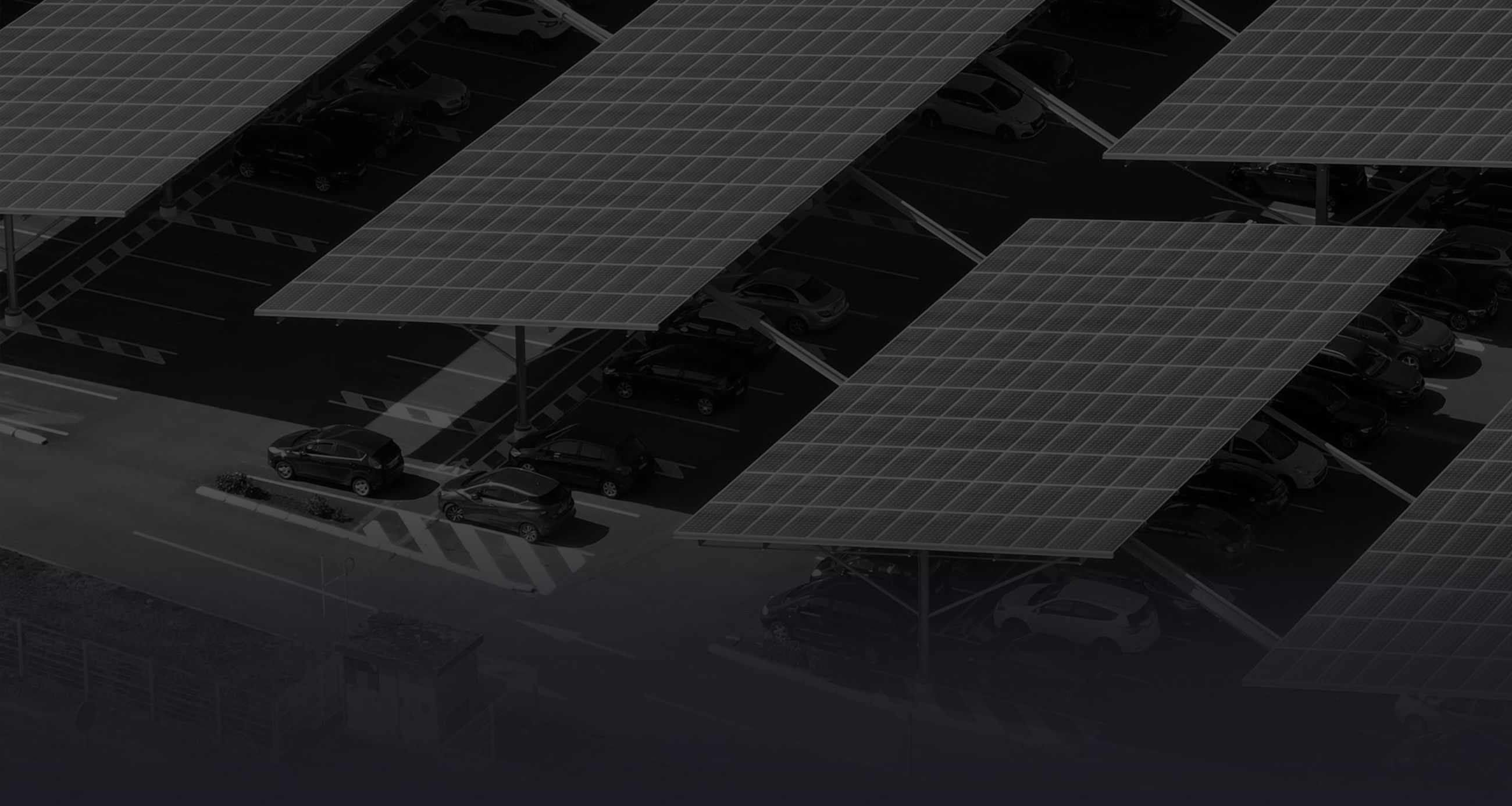 Solar panels installed in parking lot with parked cars