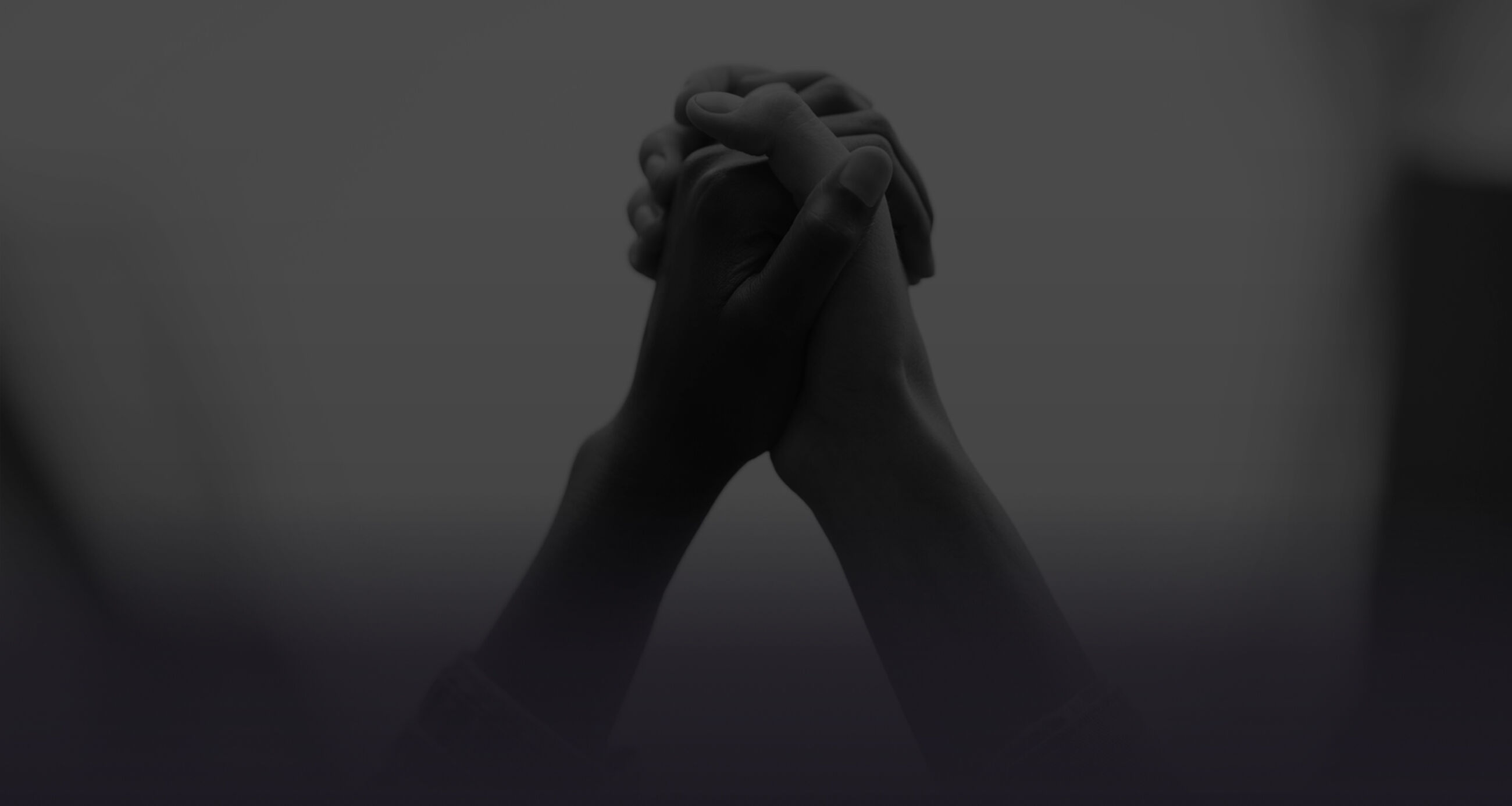 Closeup of two activists holding hands protesting