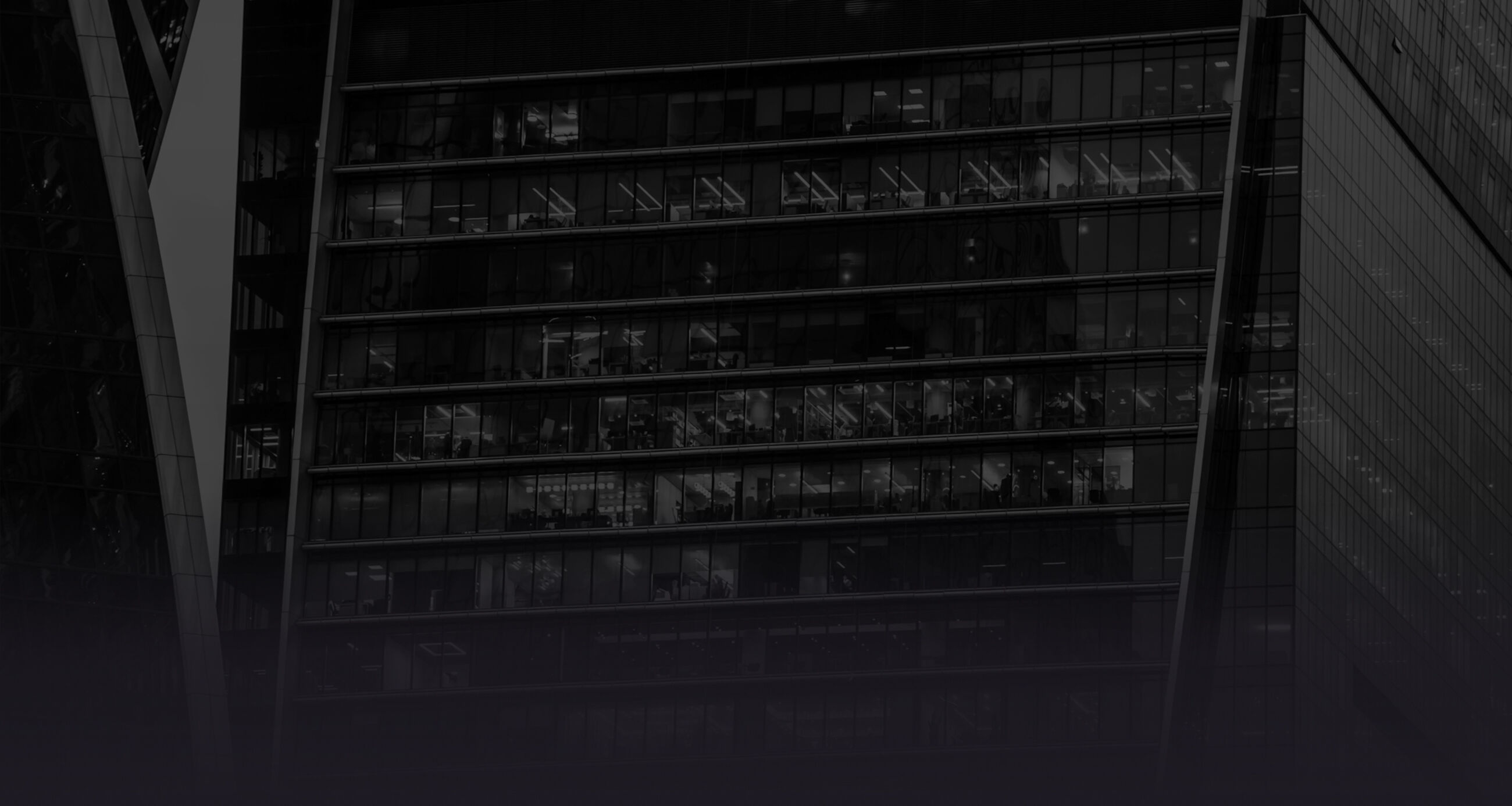 Close up of skyscraper building with office windows, evening view with turned lights