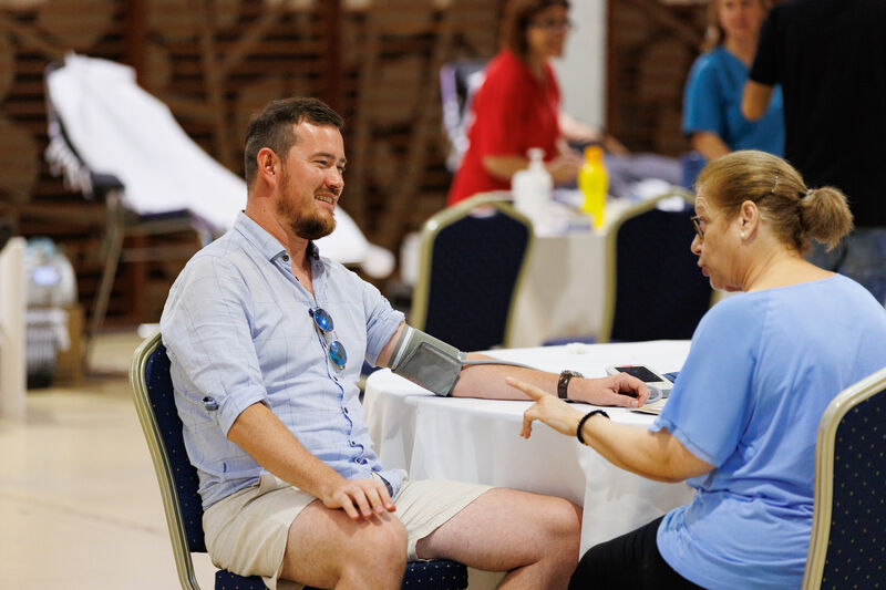 A male is undergoing a medical check before donating blood