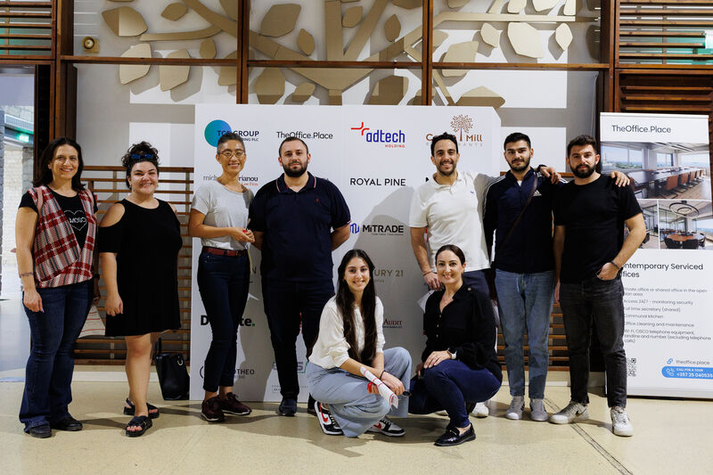 People standing in front of a photopanel wall for their picture taken