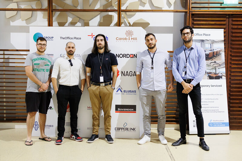 People standing in front of a photopanel wall for their picture taken