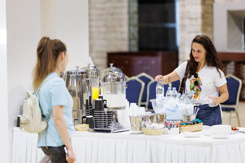 Two girls are enjoying refreshments