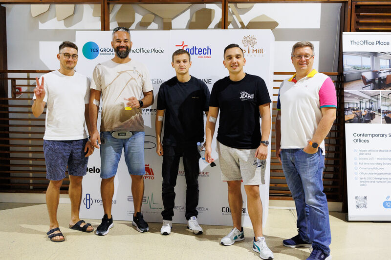 People standing in front of a photopanel wall for their picture taken
