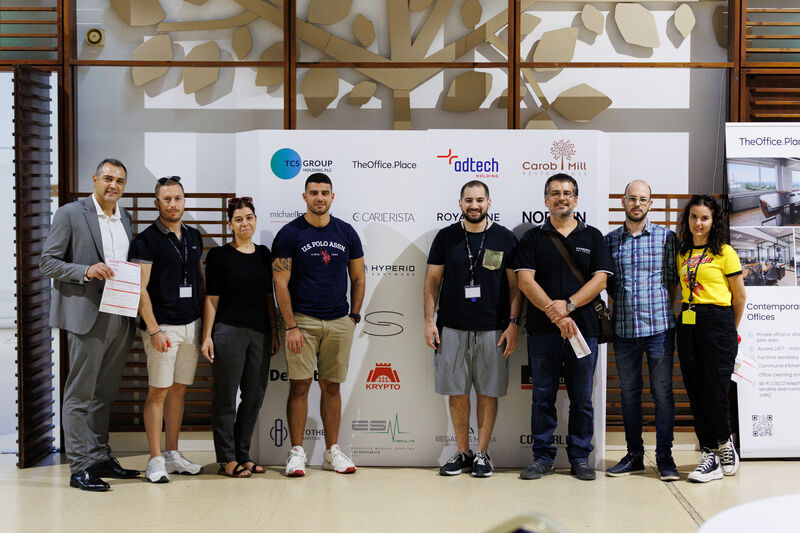 People standing in front of a photopanel wall for their picture taken